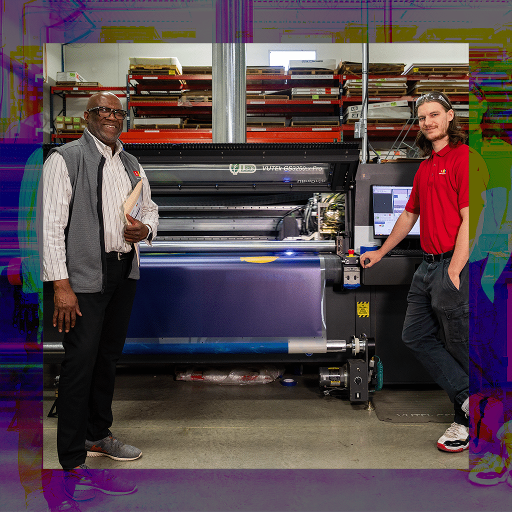 LCP Employees standing next to printer