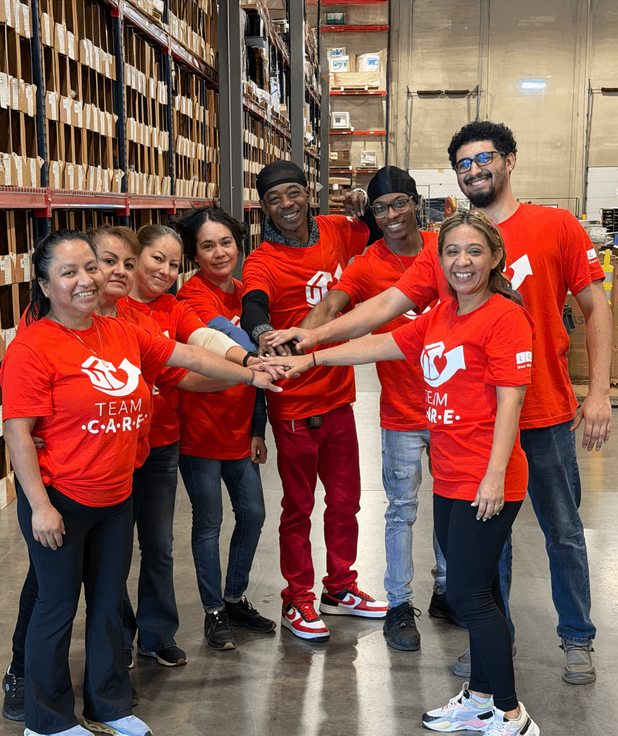 The LCP Care Team in the Warehouse doing a "Hands In" team huddle